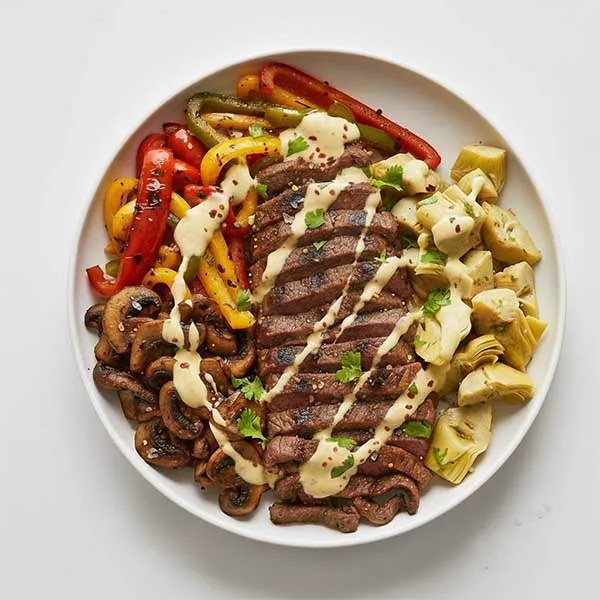 Philly Cheese Steak Bowl With Charred Pepper, Grilled Mushroom, Lime Artichoke & Jalapeno Cheese Sauce
